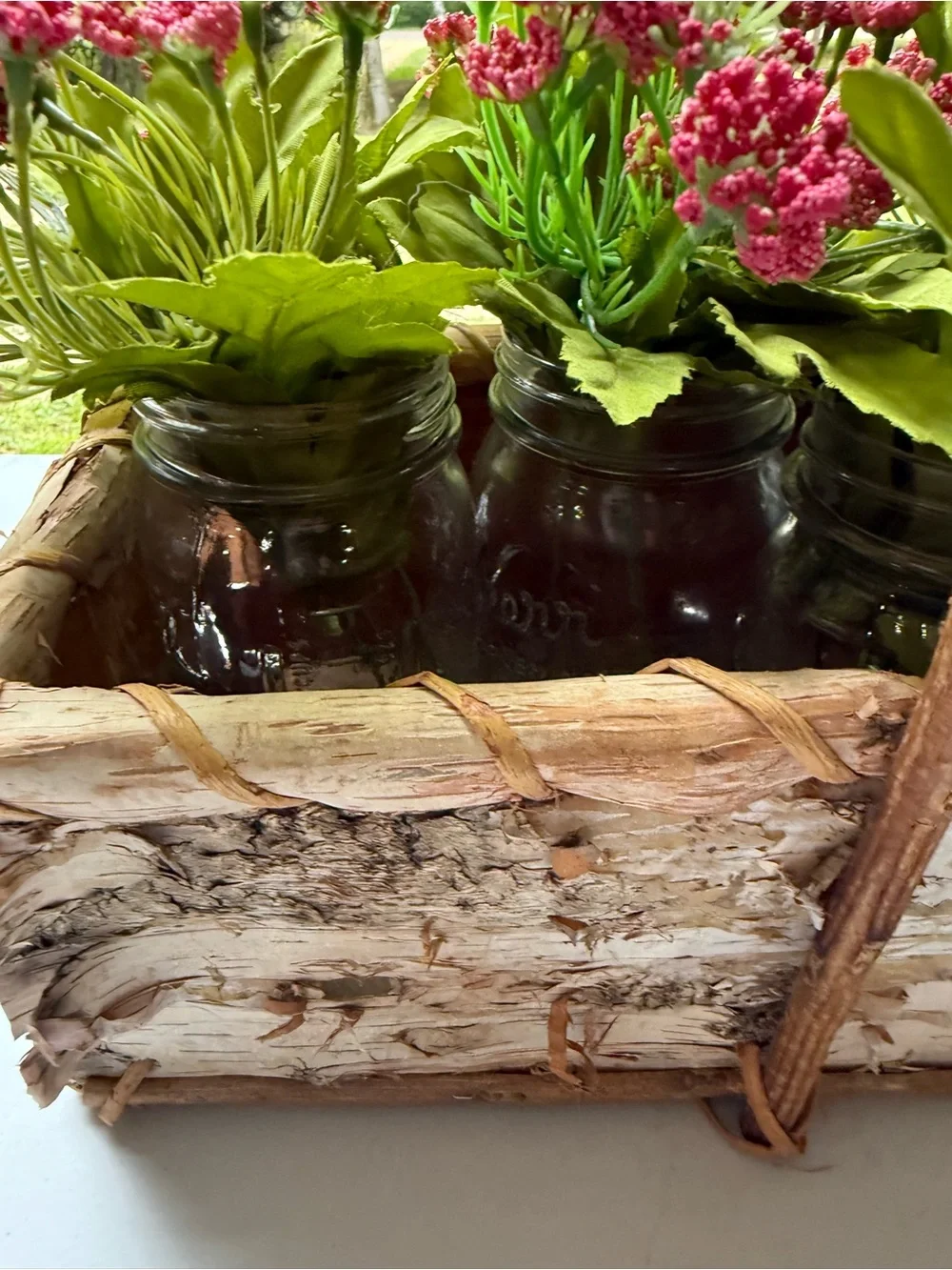 Birch basket mason jars filled with artificial flowers table decor